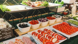 A buffet with various food options including sliced meats, vegetables, and salads. - Hotel Wielopole (Kraków)