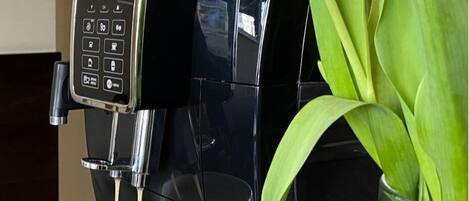 A coffee machine dispensing coffee into a cup.