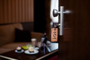 A door with a key lock and a keychain with a tag.