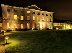 A large, two-story building with multiple windows and a symmetrical facade.