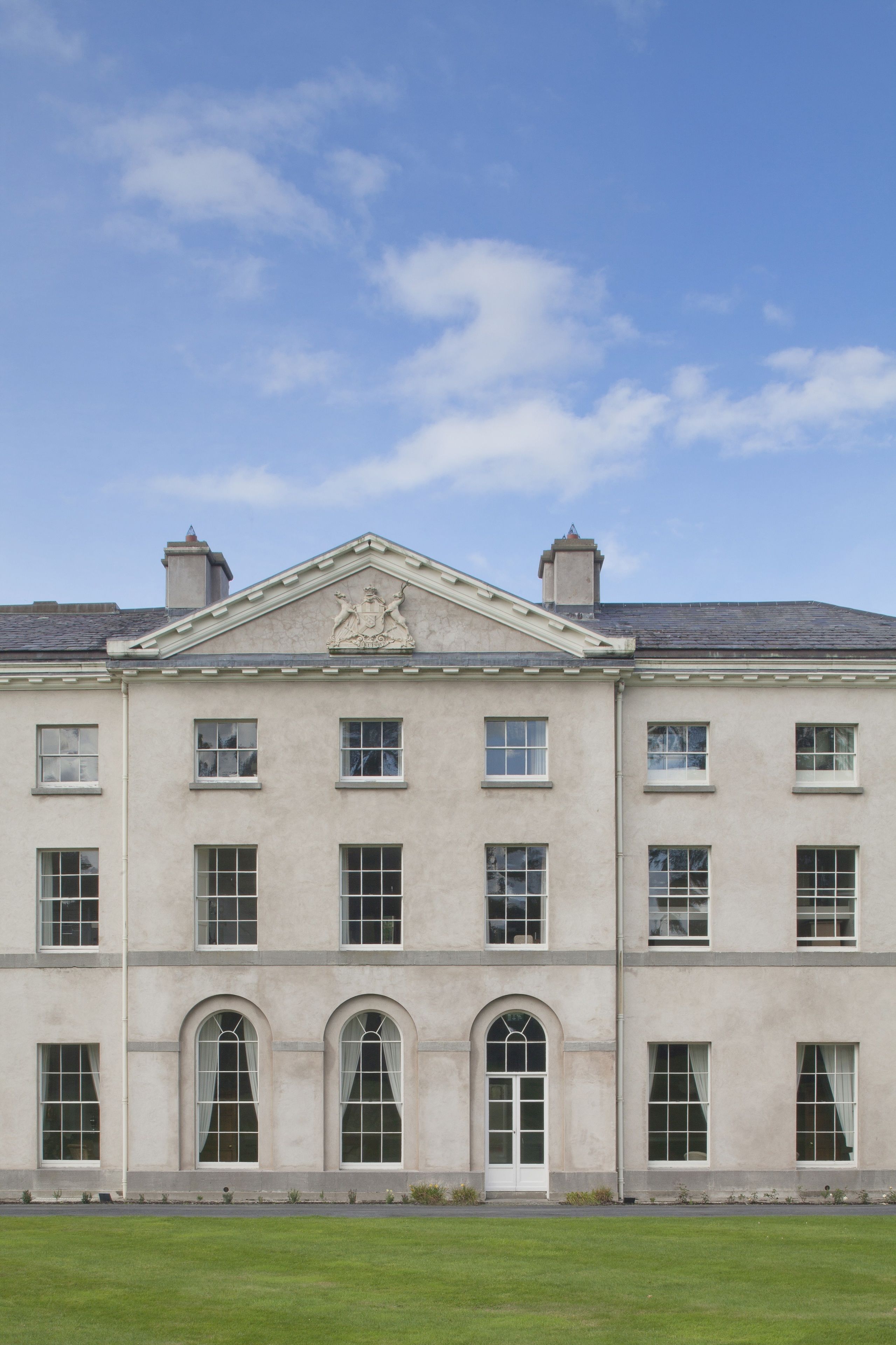 A large, stately building with a symmetrical facade, multiple windows, and a central entrance.