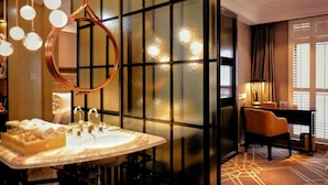 A modern bathroom with a large mirror, a marble sink, and a round light fixture. - Metropolo Classiq Shanghai Nanjing Road East Hotel (Shanghai)