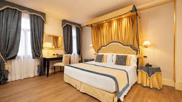 A spacious bedroom with a large bed, a desk, and a chair.
