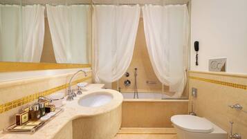 A bathroom with a sink, toilet, and bathtub.