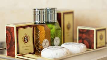 A display of various packaged goods, including a bottle and boxes, on a glass counter.