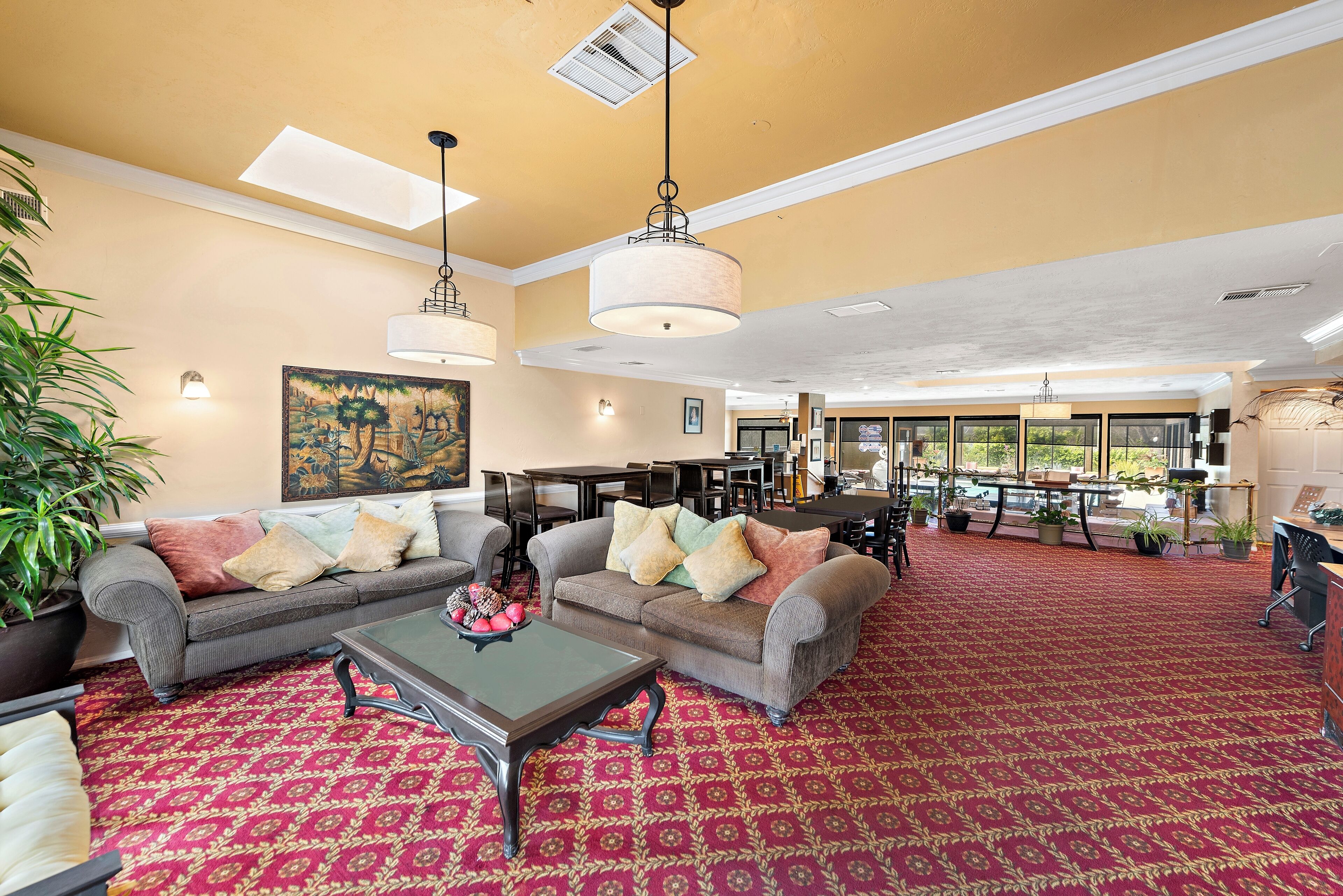 A spacious lobby with two sofas, a coffee table, and a patterned carpet.