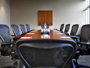 A conference room with a long table, multiple chairs, and a water dispenser. - Novotel Montreal Aeroport (Montreal)