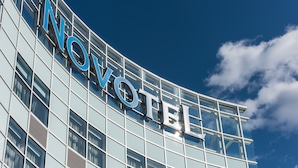 A modern hotel building with the name 'Novotel' prominently displayed on its facade. - Novotel Montreal Aeroport (Montreal)