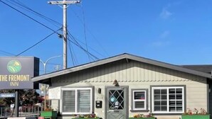 A small, single-story building with a sign for The Fremont Inn. It has a simple, functional design with a flat roof and a single entrance door.