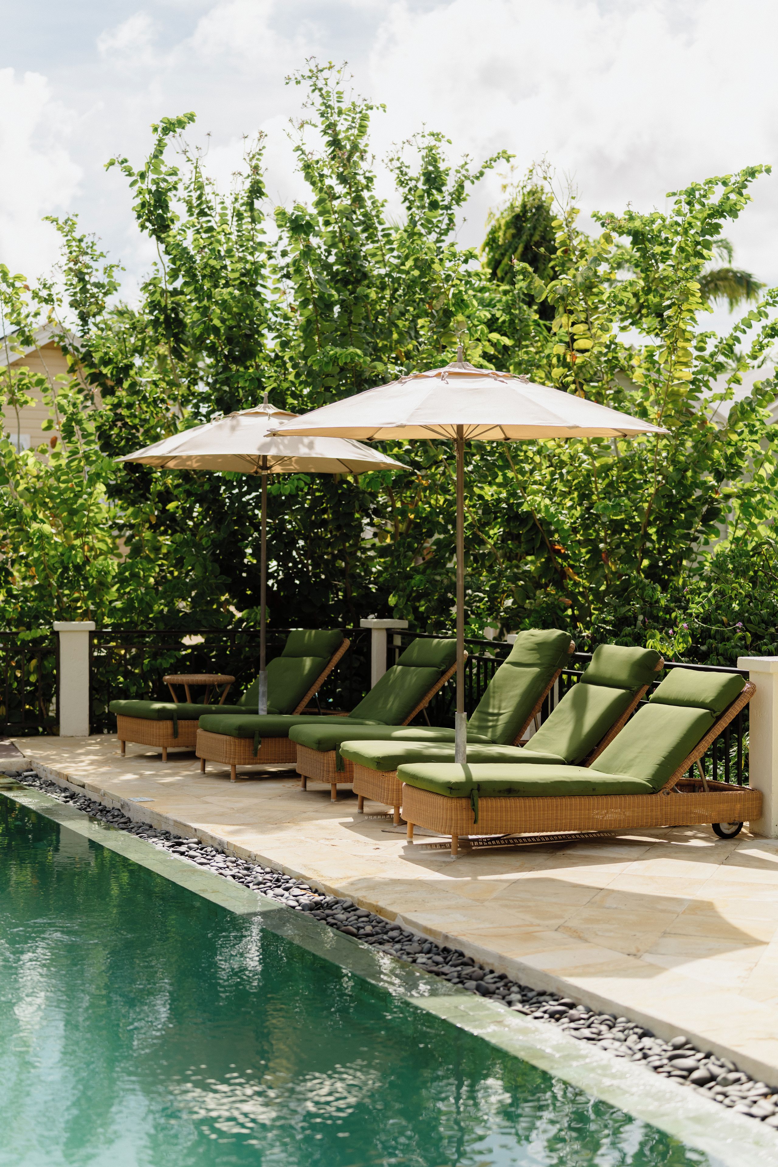 A poolside area with lounge chairs and umbrellas.