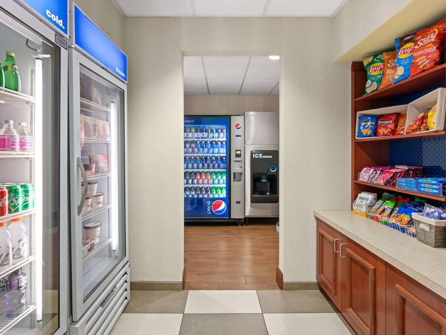 A vending area with a Pepsi cooler, a Lay's snack dispenser, and a water cooler.