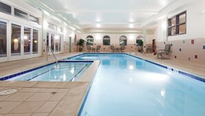 A large indoor swimming pool with clear blue water, surrounded by lounge chairs and a tiled wall. - Holiday Inn Express & Suites Gunnison by IHG (Gunnison)