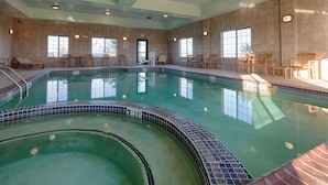 An indoor swimming pool with tiled walls and a clear water surface. - Best Western Henrietta Inn & Suites (Henrietta)