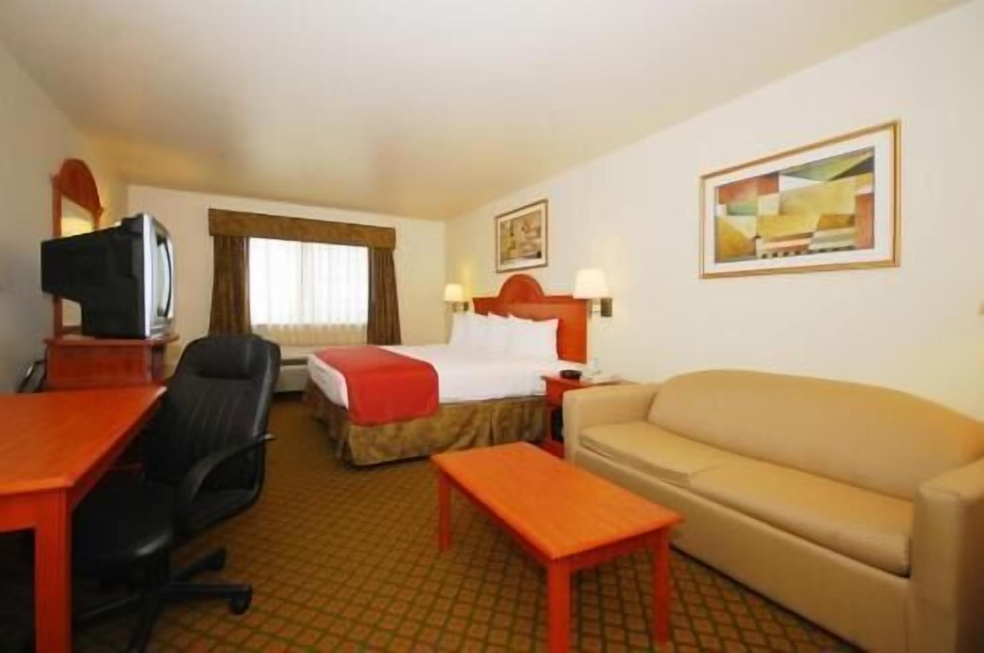 Desk, laptop workspace, blackout drapes, iron/ironing board