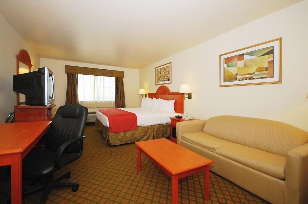Desk, laptop workspace, blackout drapes, iron/ironing board