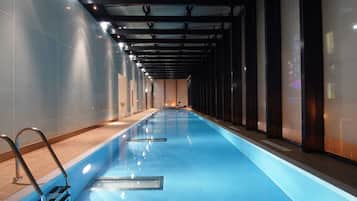 Swim and relax in our indoor pool area, featuring a rectangular pool and metal ladder for easy access.