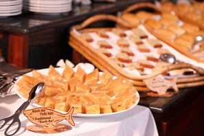 A buffet with various food items, including a plate of traditional Vietnamese confections.