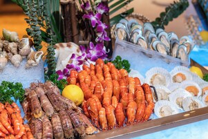 A seafood display with various types of shellfish and prawns.