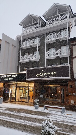 A hotel with a prominent sign reading "Lennox Hotels Ushuaia." -  Lennox Hotel Ushuaia (Ushuaia)
