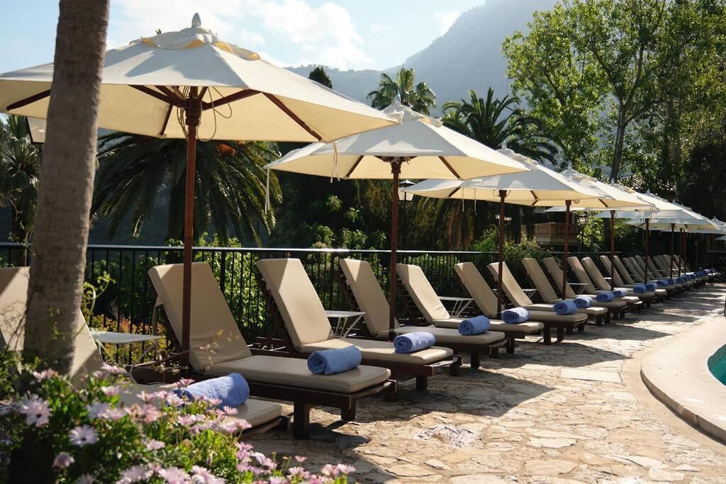 Outdoor pool, open 10:00 AM to 7:00 PM, pool umbrellas, pool loungers