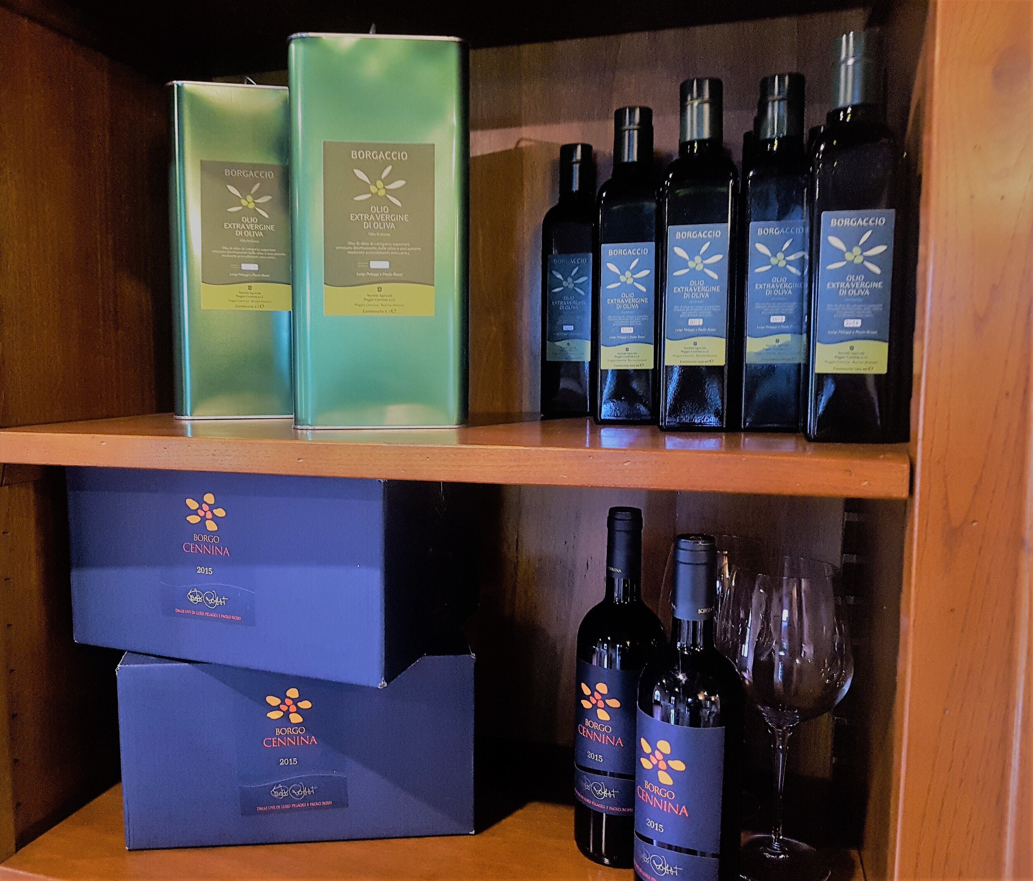 A wooden shelf with wine bottles and boxes.