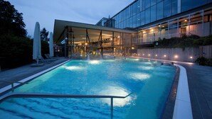 A swimming pool with a modern building in the background.