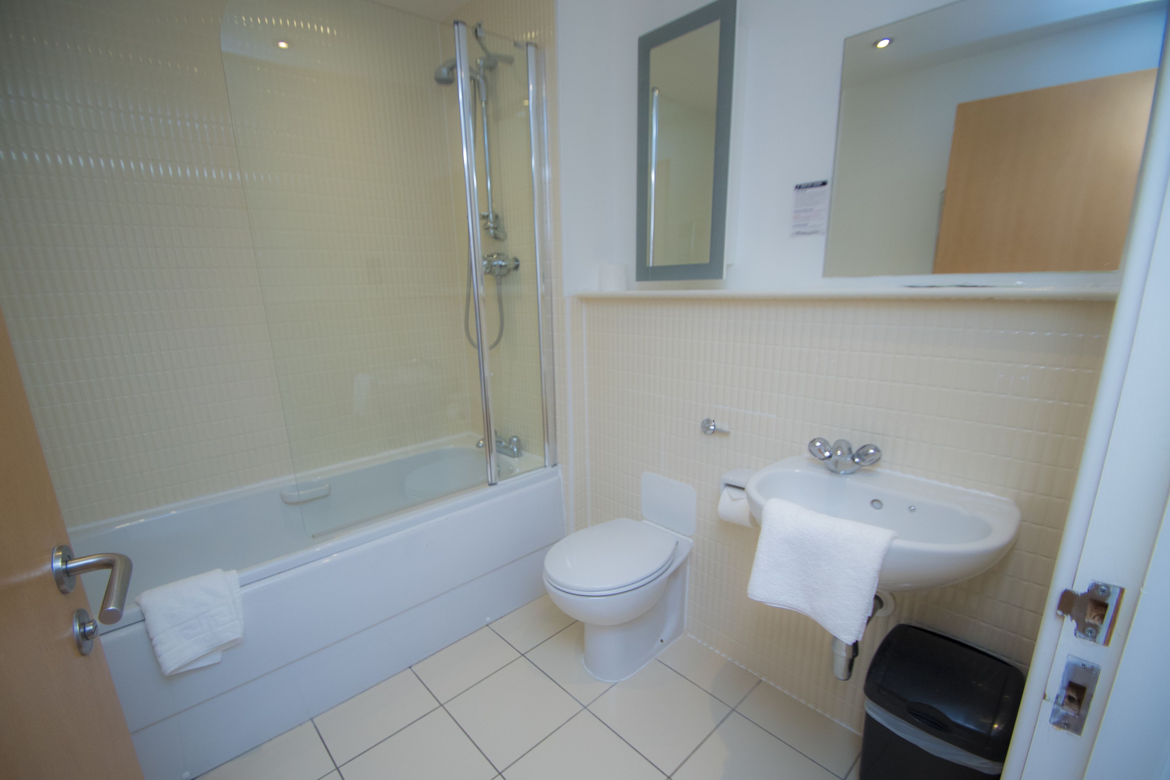 A bathroom with a bathtub, toilet, and sink.