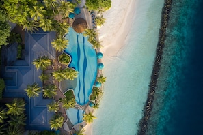 An aerial view of a resort with a swimming pool, palm trees, and a beach. - Royal Island Resort & Spa (Horubadhoo Island)