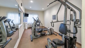 A gym with treadmills, an elliptical, and a weight machine. - Super 8 by Wyndham St Robert Ft Leonard Wood Area (St. Robert)