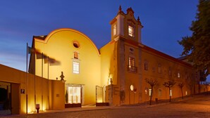 A historic building with a prominent bell tower and a large arched entrance.