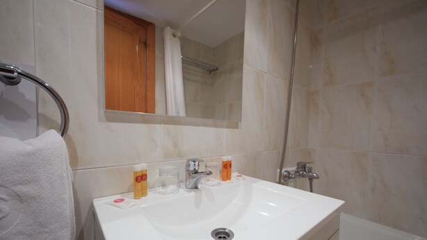 A bathroom with a white sink, mirror, and shower. - Hotel JS Paradise Sport - Adults Only (Llucmajor)
