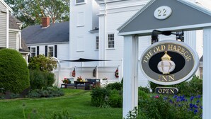 A sign for The Old Harbor Inn with a number 22 on the building. - Old Harbor Inn (Chatham)