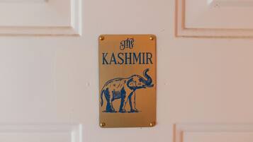 A sign with an elephant and the text 'The Kashmir' on a white door.