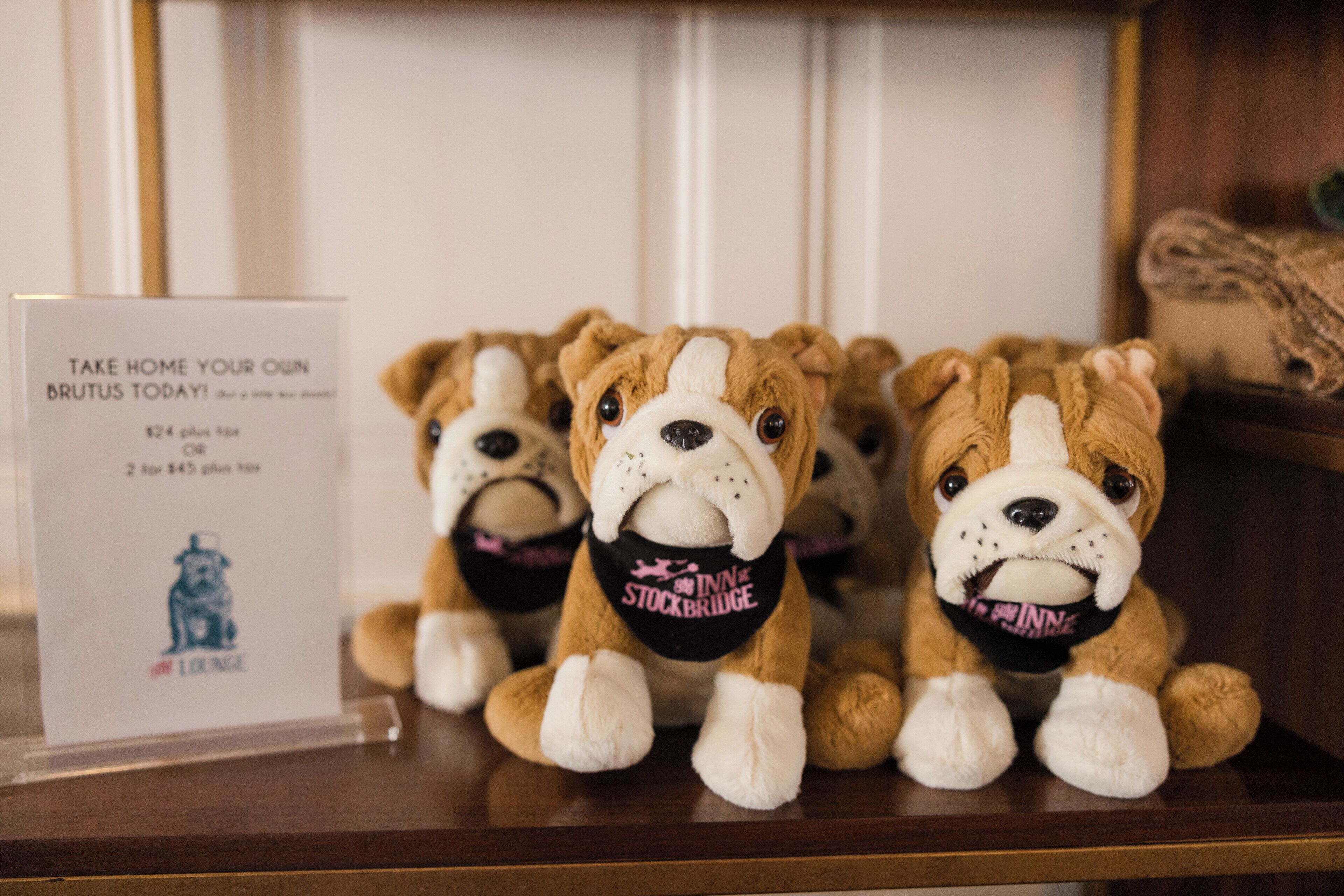 A display of stuffed animals with a sign advertising a promotion.