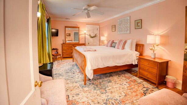 A bedroom with a bed, dresser, nightstand, and a ceiling fan. - The Inn at Stockbridge (Stockbridge)