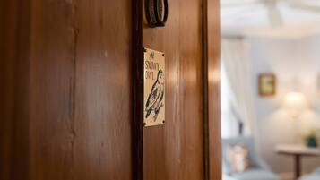 A wooden door with a sign that reads 'The Snowy Owl.'