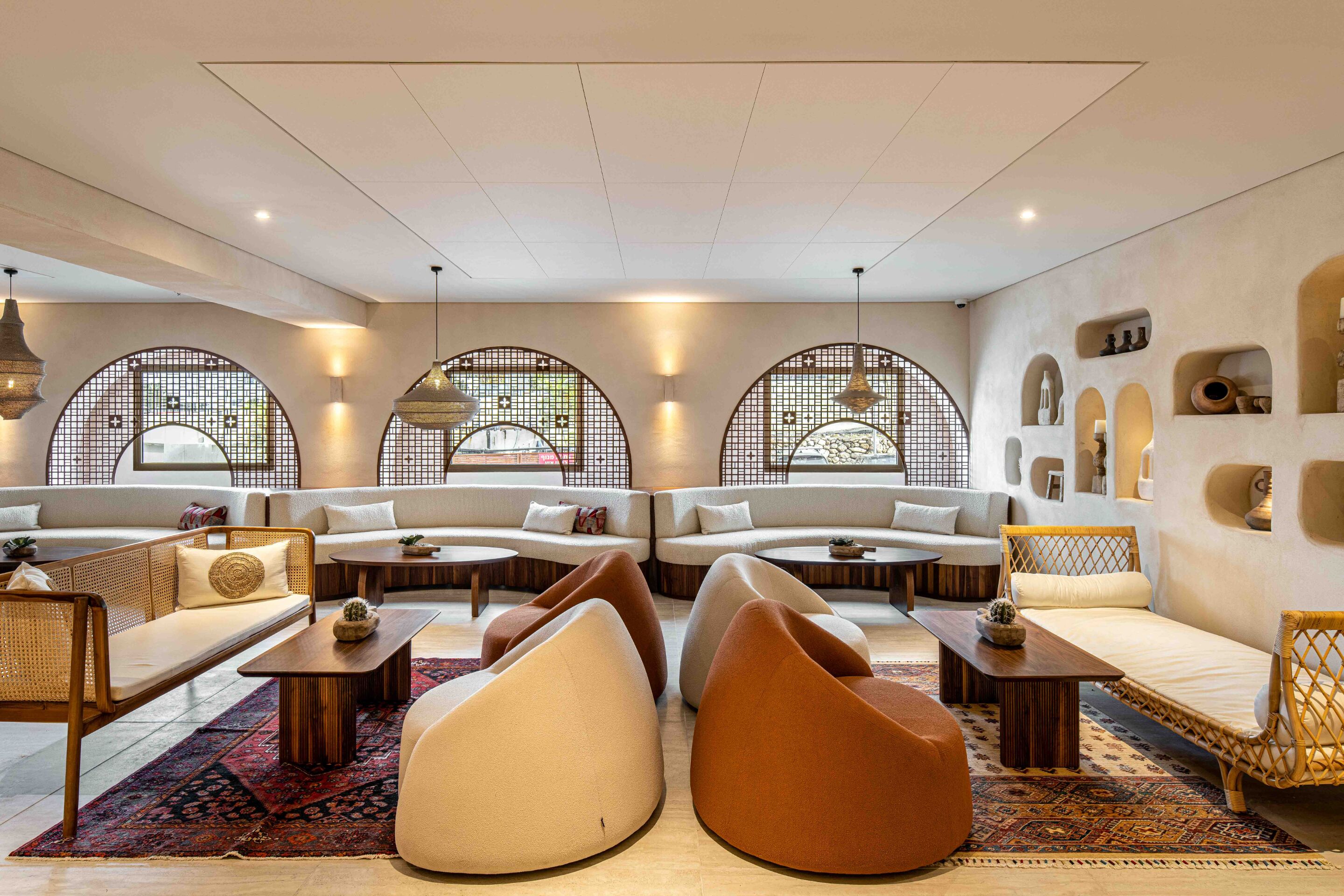 A modern lounge area with sofas, armchairs, and a coffee table.