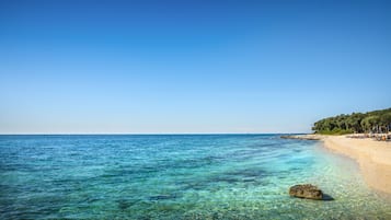 On the beach, sun loungers, beach umbrellas, water skiing