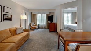 A hotel room with a sofa, a TV, a desk, a chair, and a bed. - Residence Inn by Marriott Morgantown Medical Center Area (Morgantown)