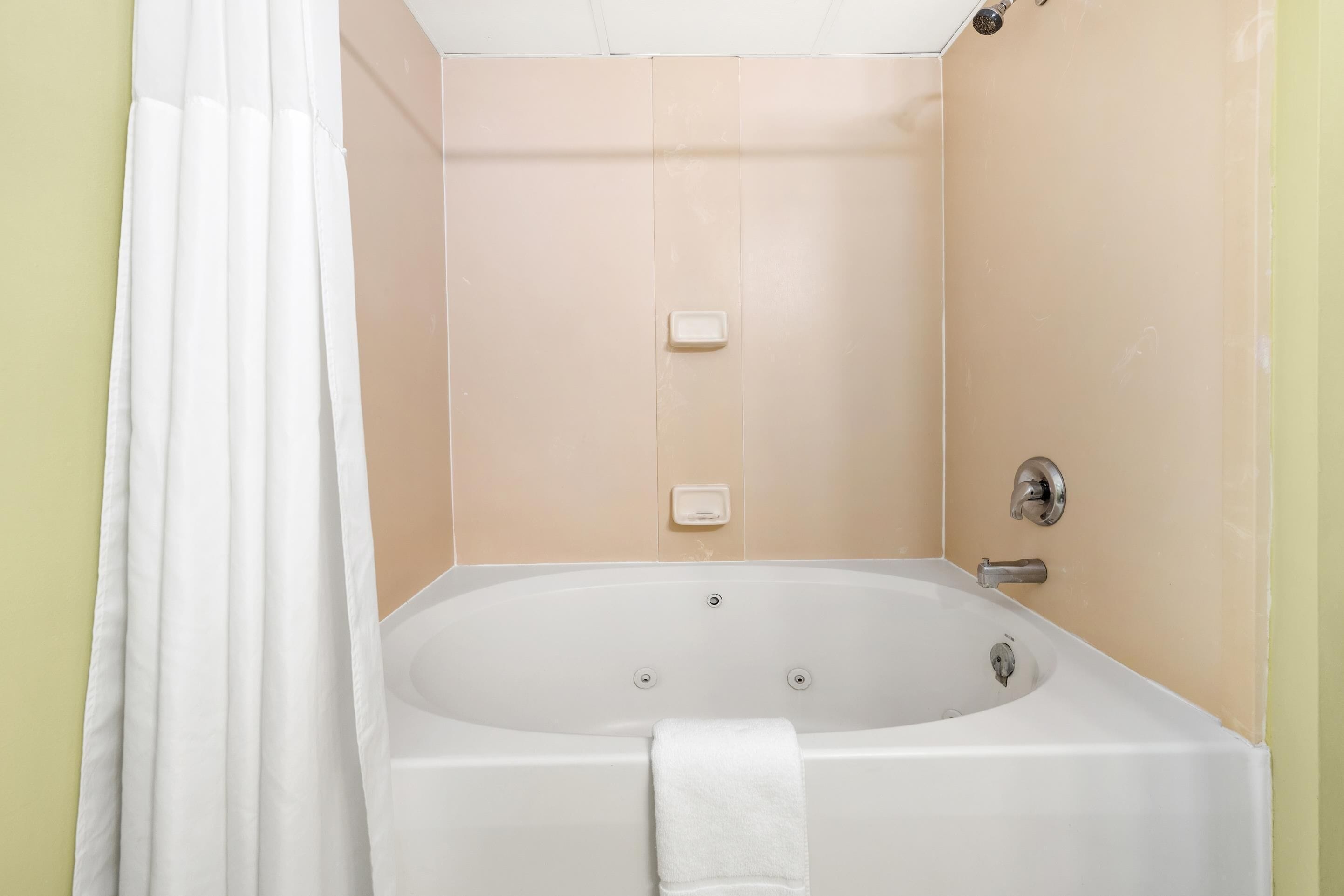 A bathroom with a bathtub, a shower, and a toilet.