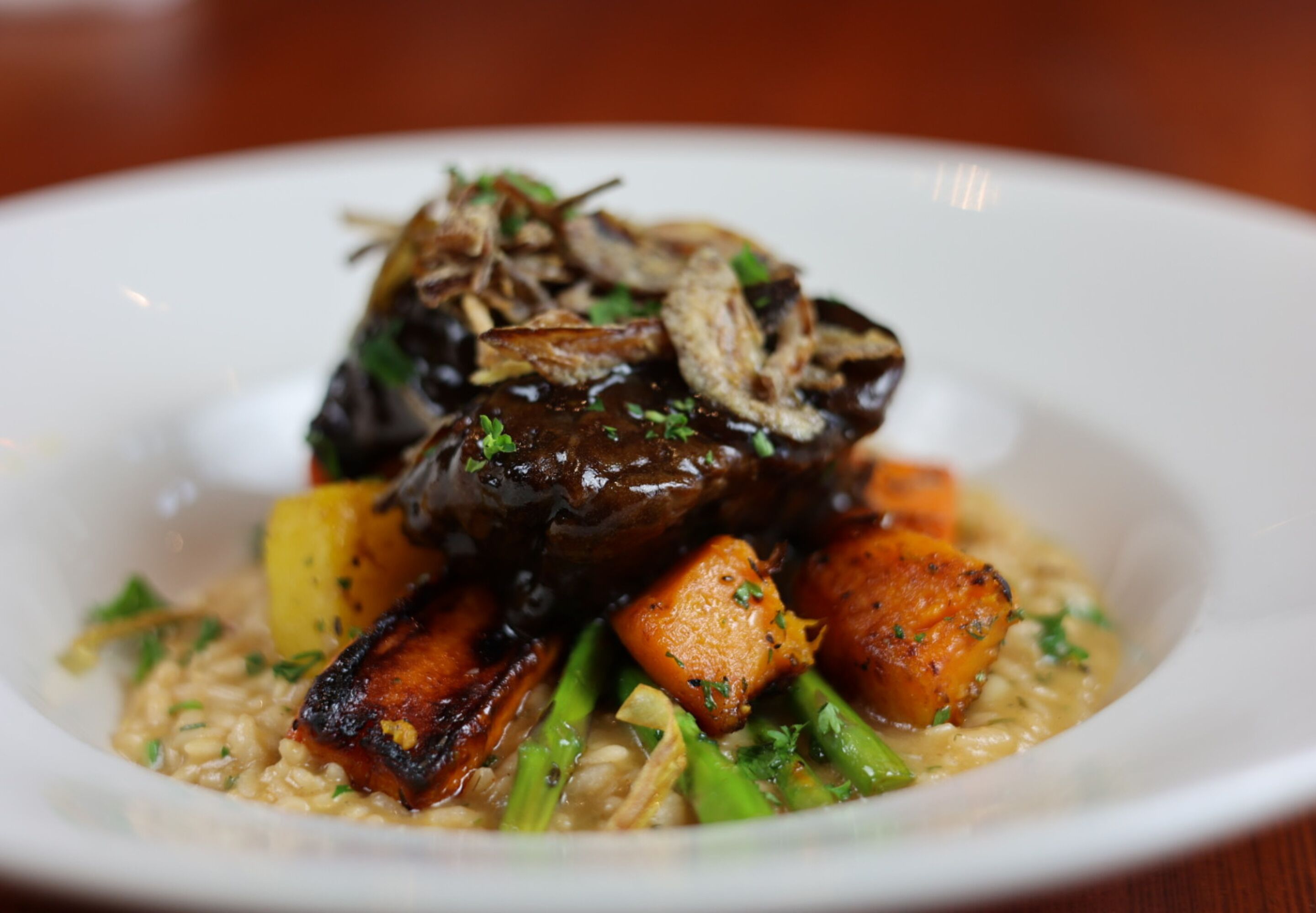 A plate of food with a variety of vegetables and a dark, glossy sauce.