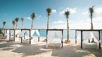 Private beach, white sand, beach umbrellas, motor boating
