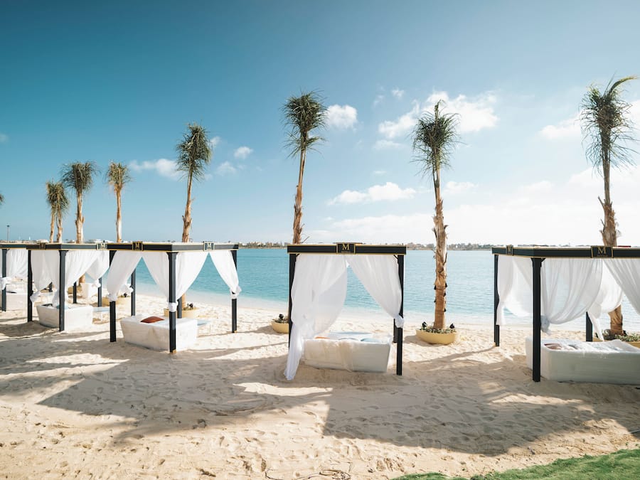 Private beach, white sand, beach umbrellas, motor boating