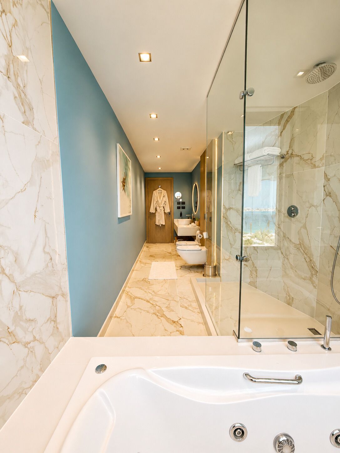 A modern bathroom with a glass-enclosed shower, a large bathtub, and a vanity with a mirror.
