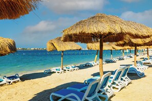 Private beach, white sand, beach umbrellas, motor boating