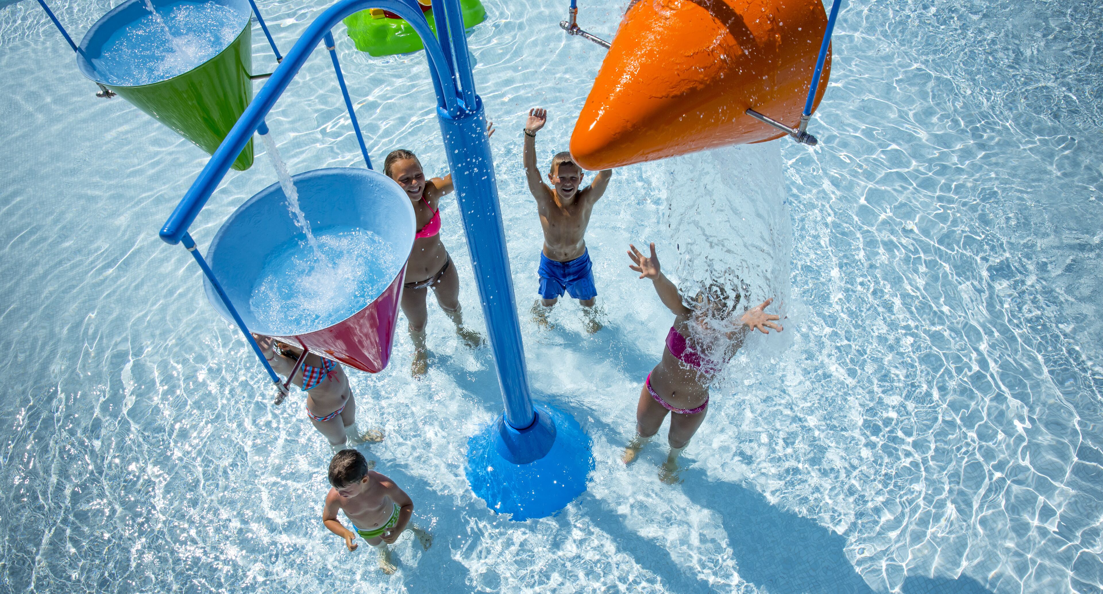 A water play area with multiple buckets and a central water feature.