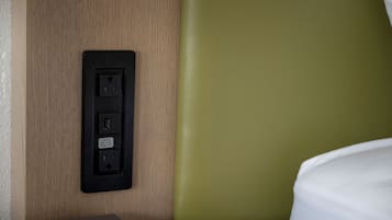 A wall-mounted power outlet with USB ports and a label.