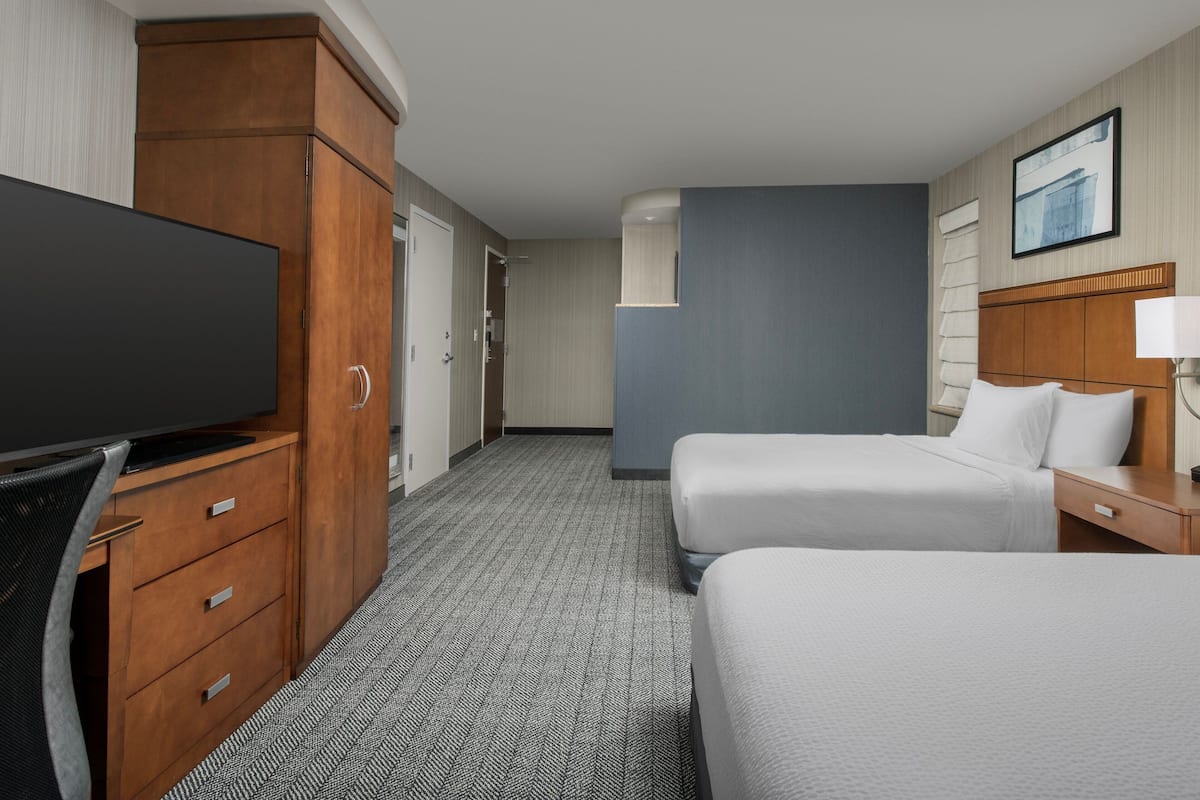 Premium bedding, desk, laptop workspace, blackout drapes