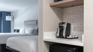 A hotel room with a bed, a small kitchenette with a microwave, coffee maker, and refrigerator. - Holiday Inn Express Hotel & Suites Drums by IHG (Drums)