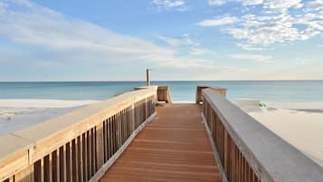 On the beach, white sand, sun loungers, beach umbrellas